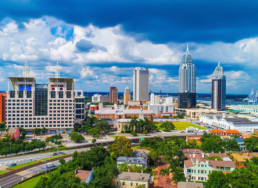 About Our Agency - Aerial View of Downtown Mobile, Alabama on a Cloudy Day