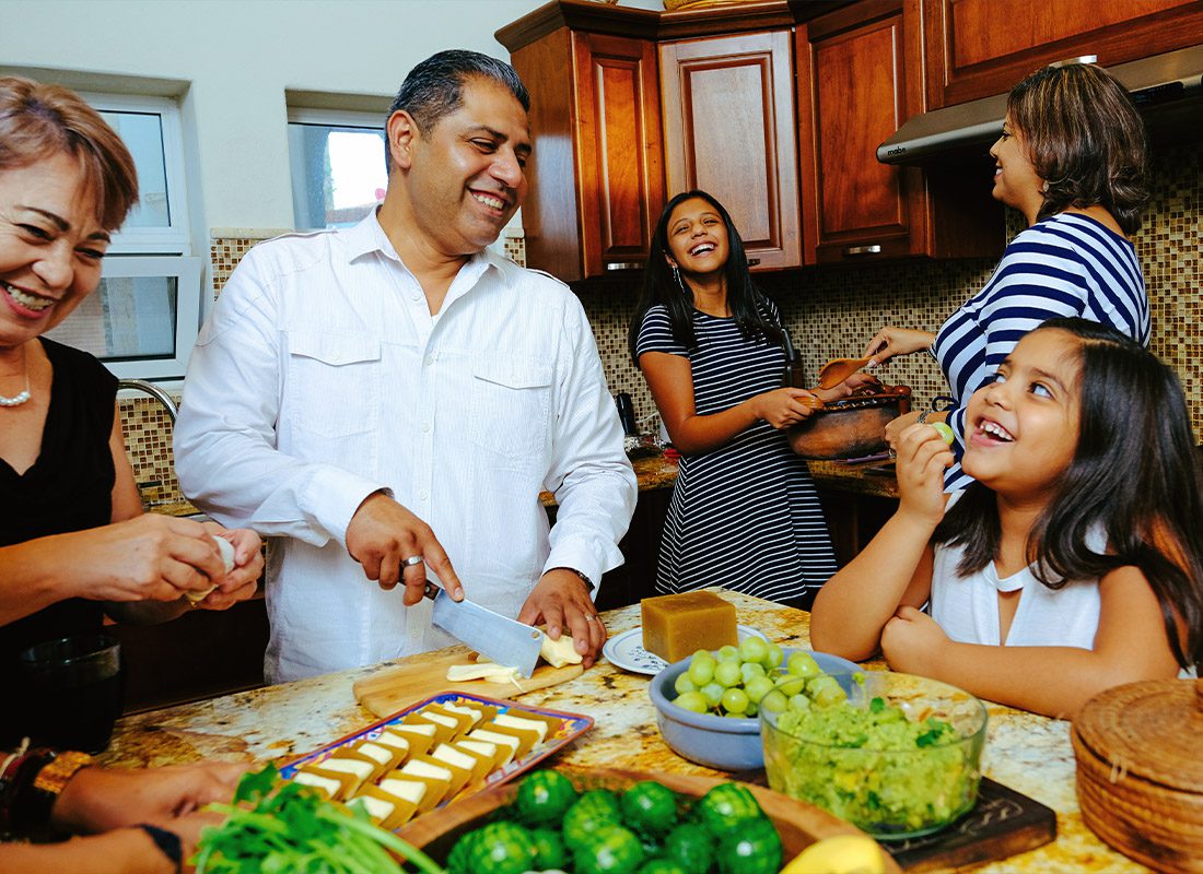 Personal Insurance - A Joyful Family Preparing Dinner Together